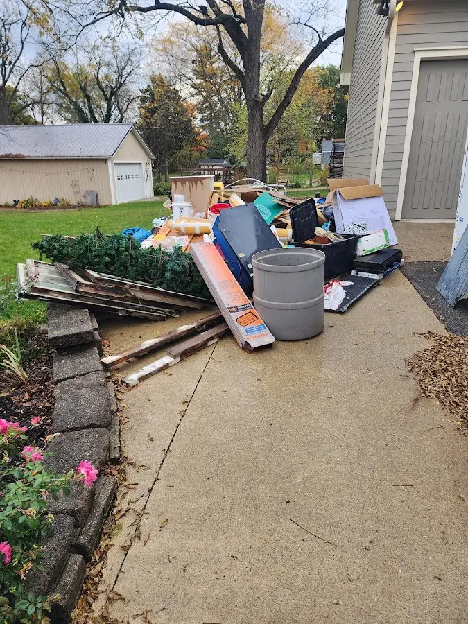 Dumpster being loaded with debris for 12 Yard Dumpster Rental in Booneville